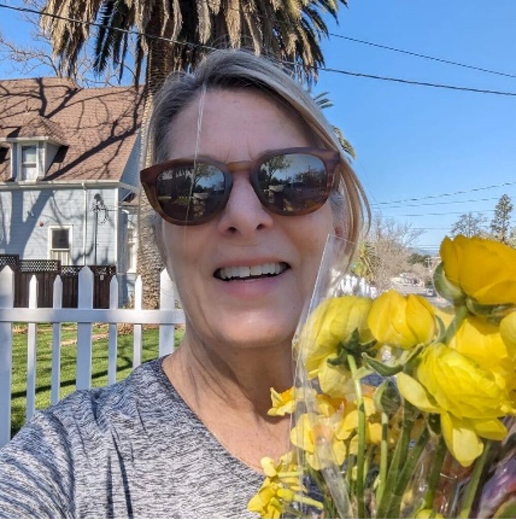 Lisa Fairchild, relationship coach, with yellow flowers